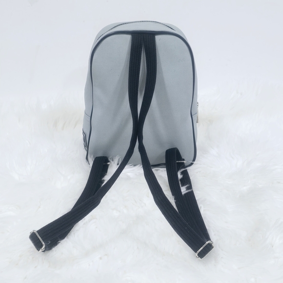 Lacoste mini backpack in a soft light blue shade with navy blue trim accents. - Picture 3 of 16